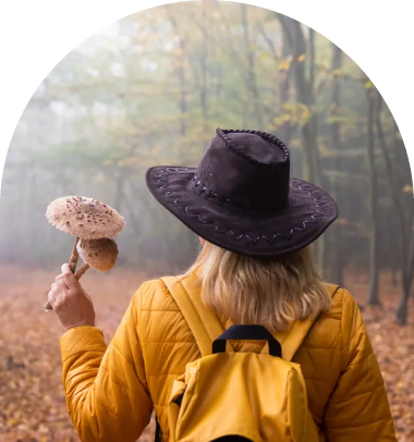 A woman in yellow jacket holding an umbrella.