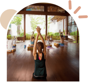 A group of people doing yoga in a room.