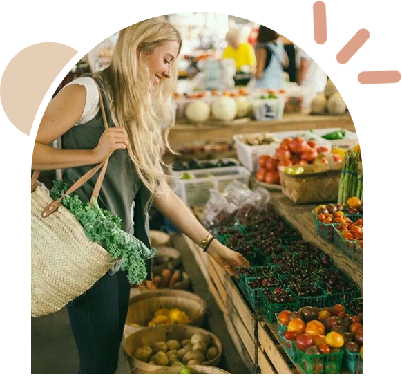 A woman shopping at an outdoor market.