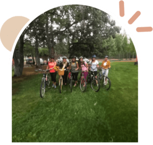 A group of people standing next to each other on bikes.