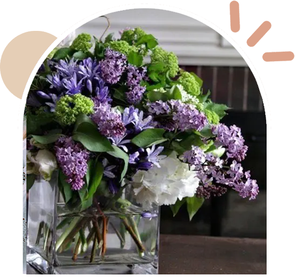 A vase filled with purple flowers on top of a table.